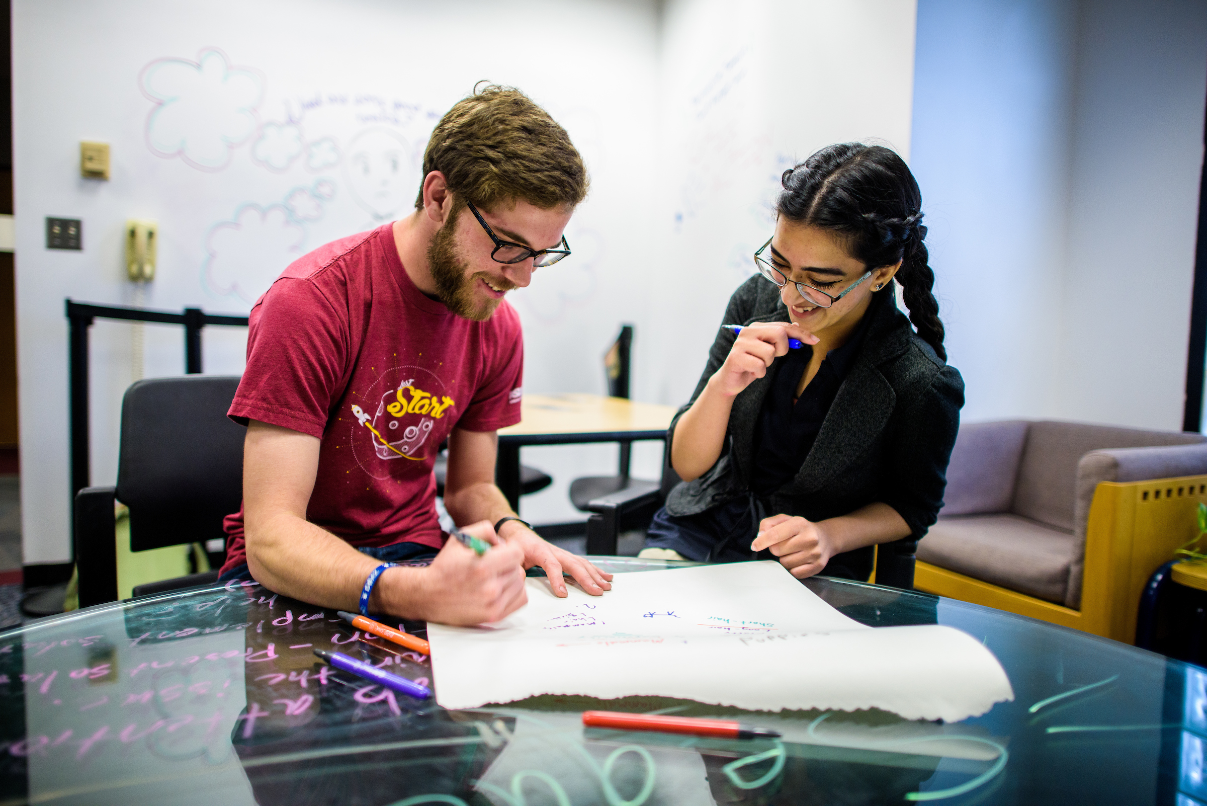 Image of students working on a drawing together
