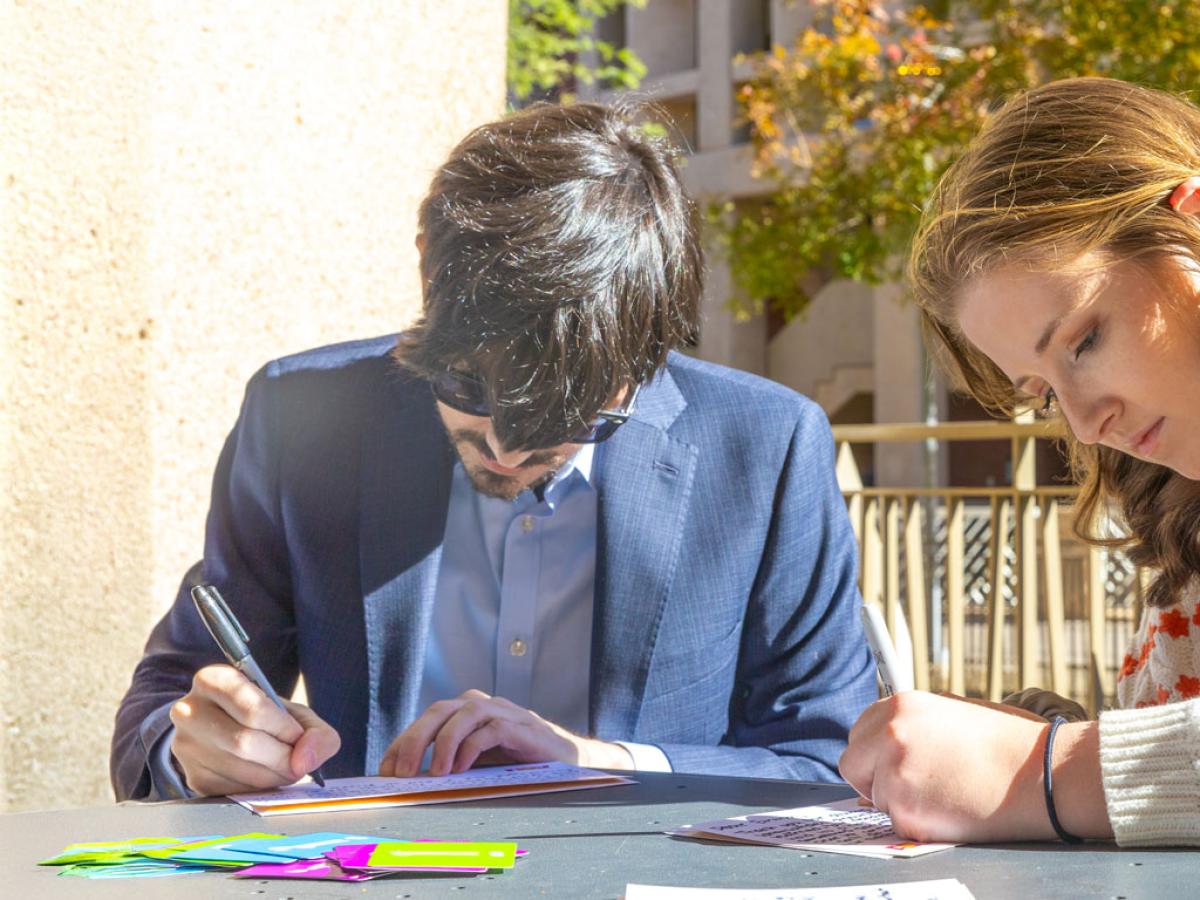 two students writing note cards